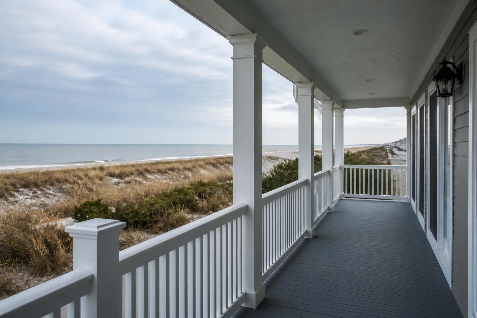 Porch of a coastal Delaware home overlooking dune grass and the ocean