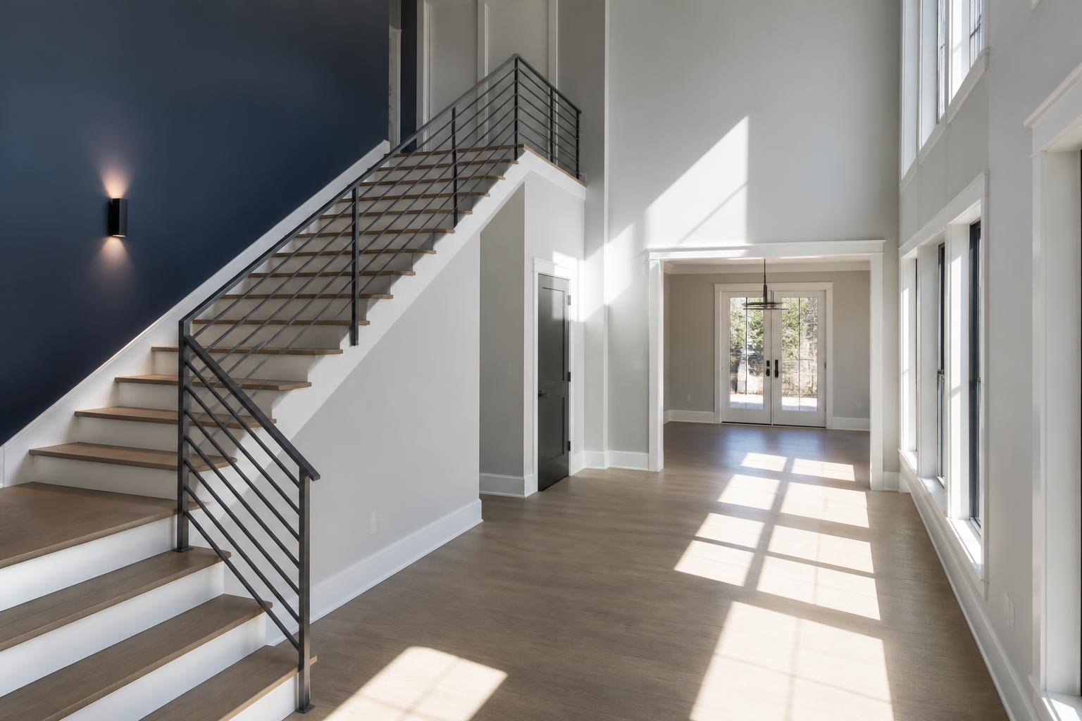 Newly finished interior with a bright double-height entry, new stair and crisp trim